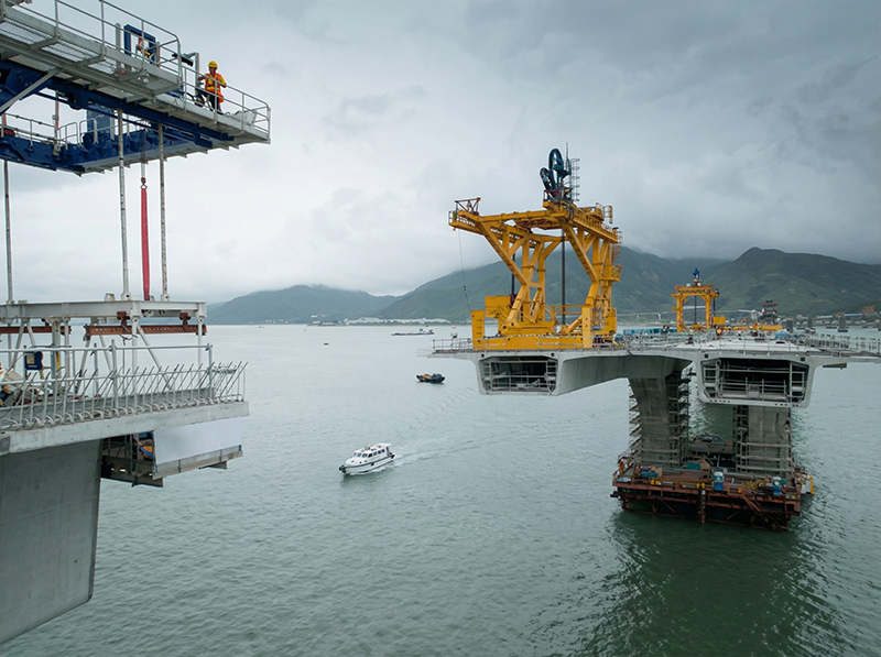 Bridgent engineers overseeing bridge deck erection over water