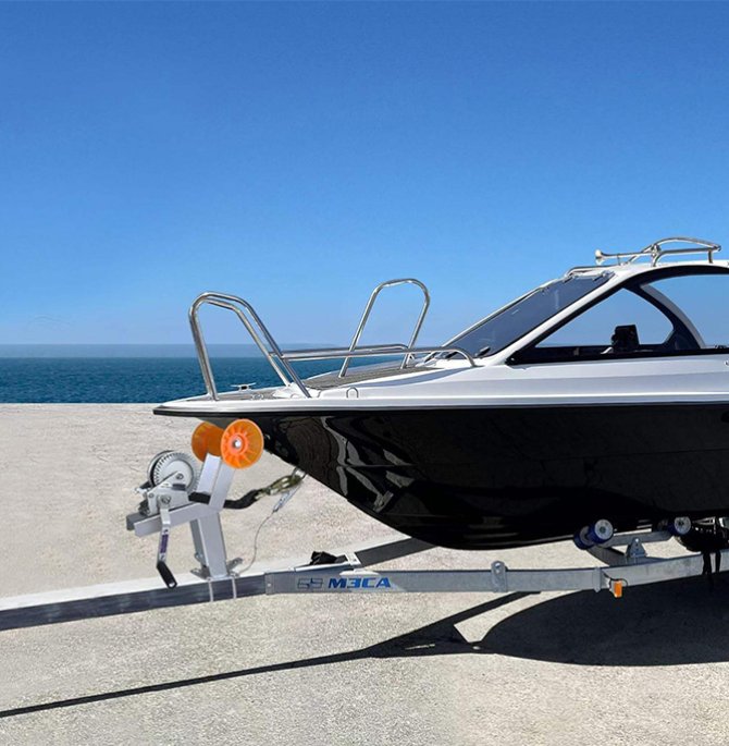 Adjustable boat trailer winch bracket with casters