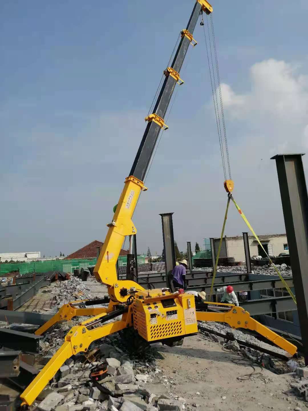 LIFTSGLT mini tracked crane with fully extended telescopic boom lifting steel components on a confined construction site