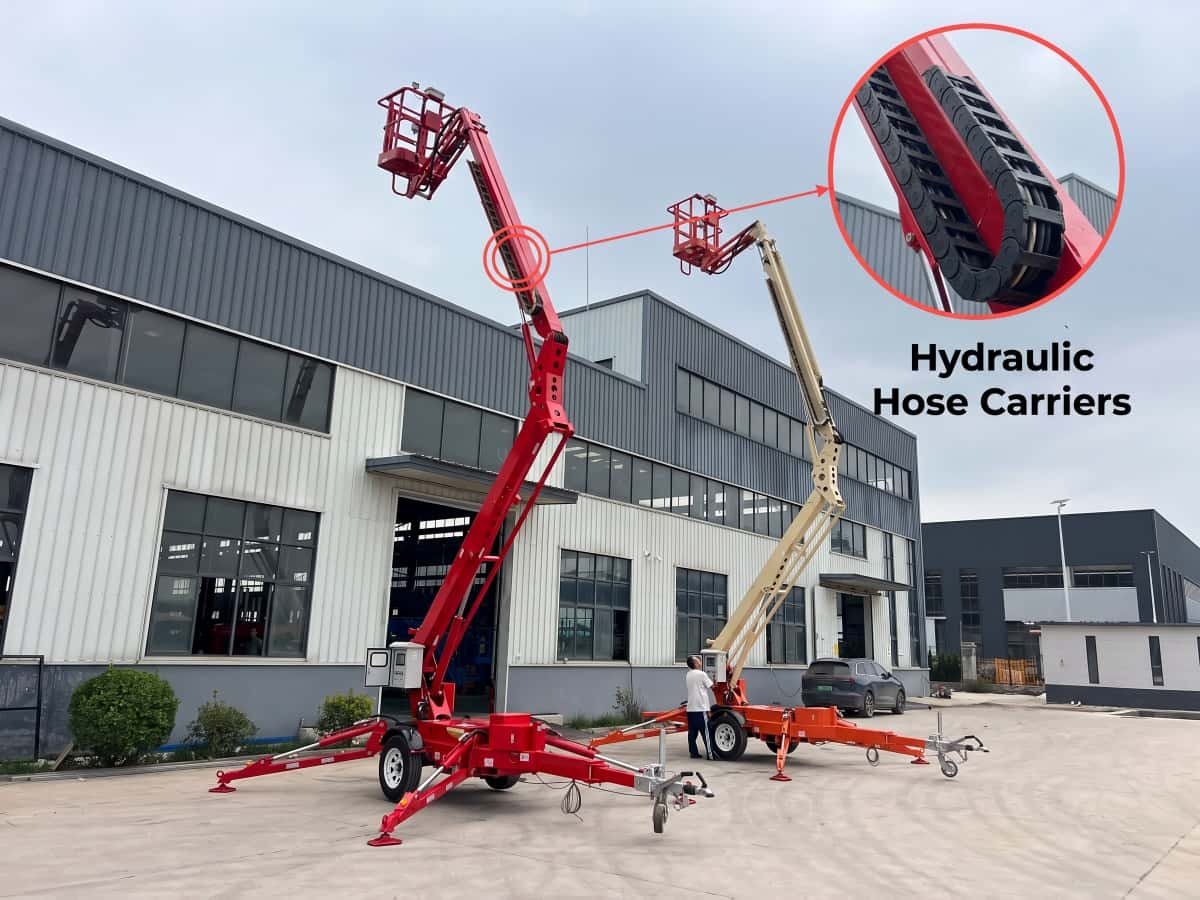 Elevated towable articulating boom lift showing functional hydraulic hose carrier protecting lines at maximum working height.